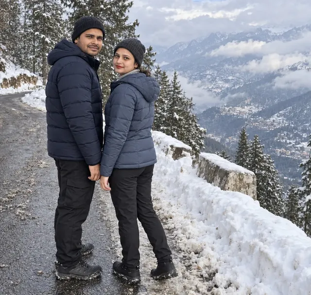 Nav and Vandana on the snowy road up to Auli, cloud filling the valley below