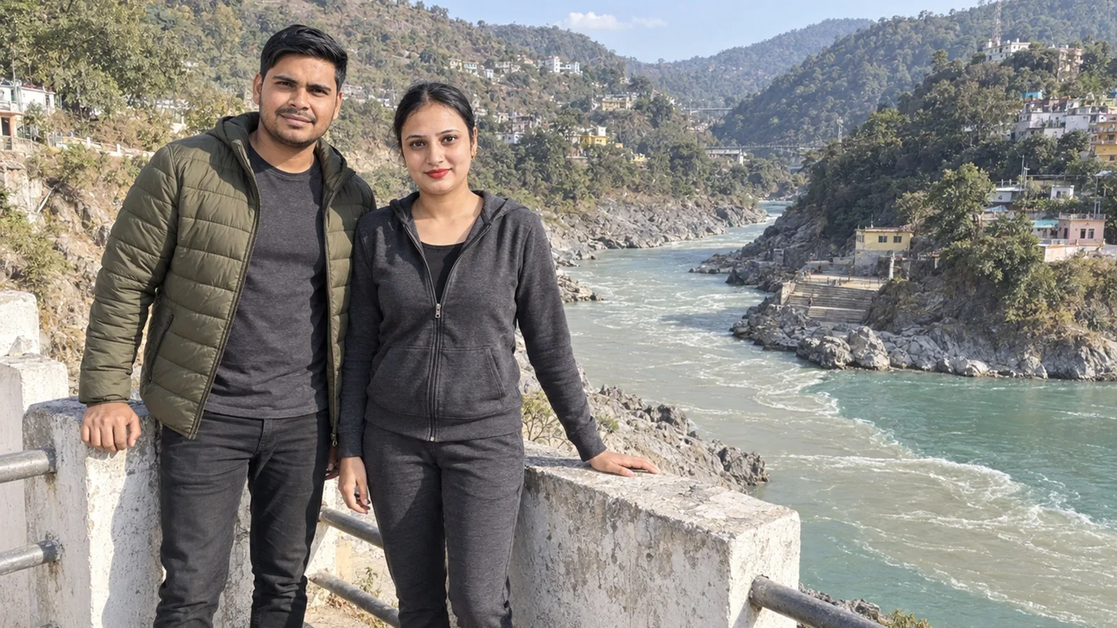 Nav and Vandana at a railing above a turquoise river confluence on the road to Joshimath
